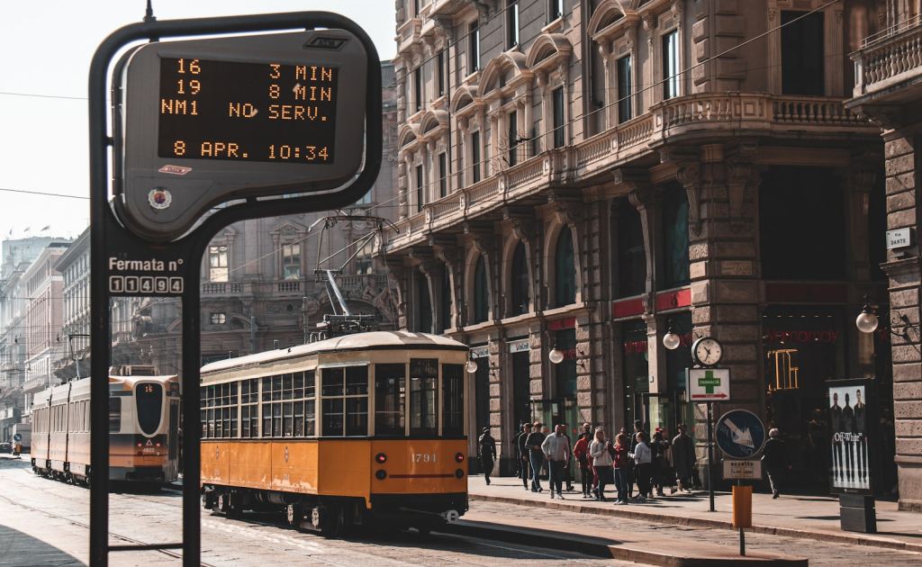 a yellow and white trolley on a city street