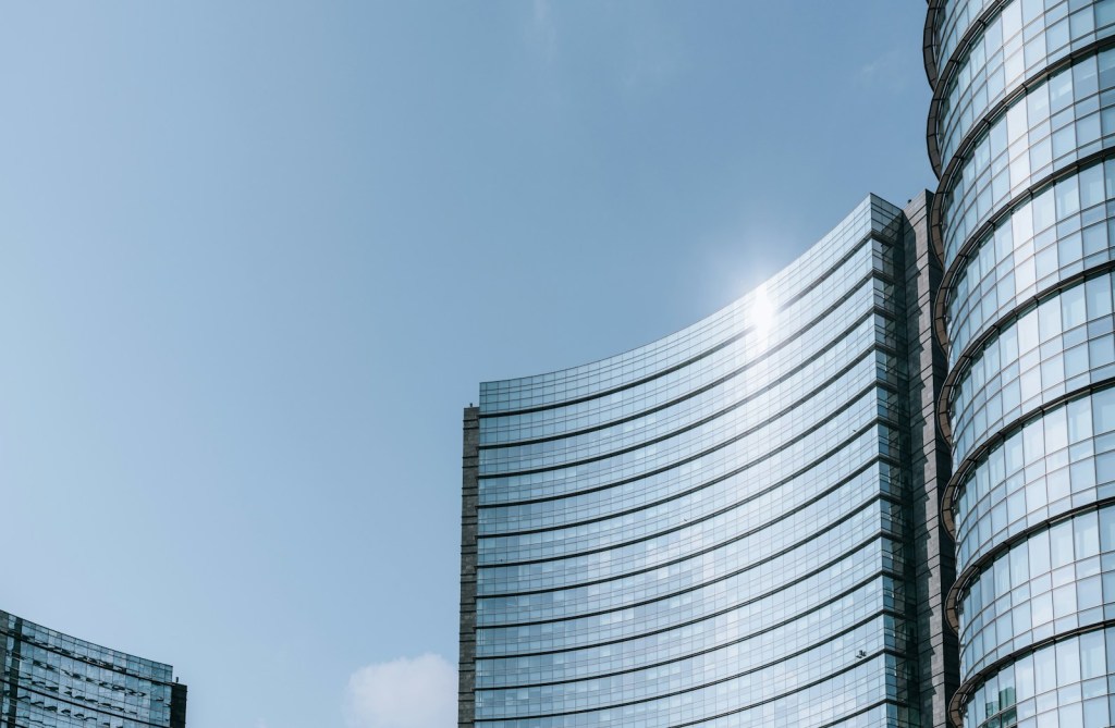 Milan a very tall building next to a very tall building