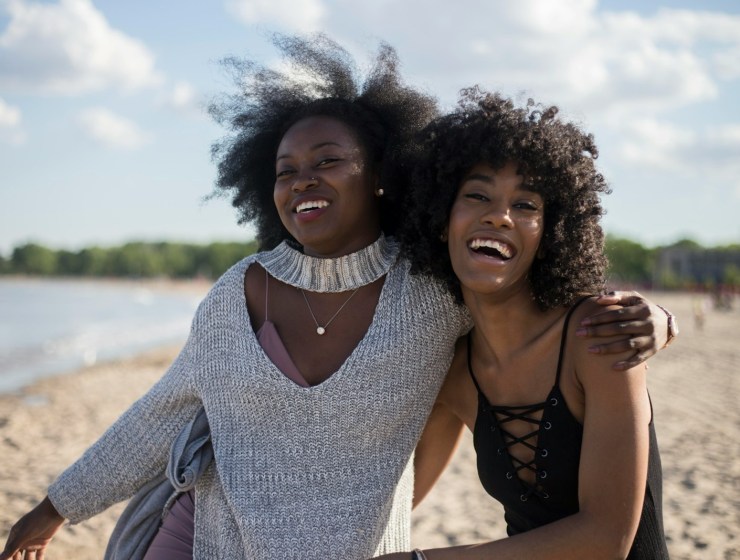 photo of woman beside another woman at seashore
