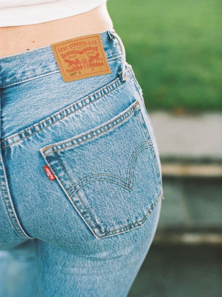 shallow focus photo of person wearing jeans
