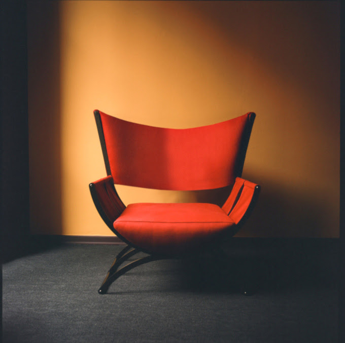 red designer armchair by Pier Fausto