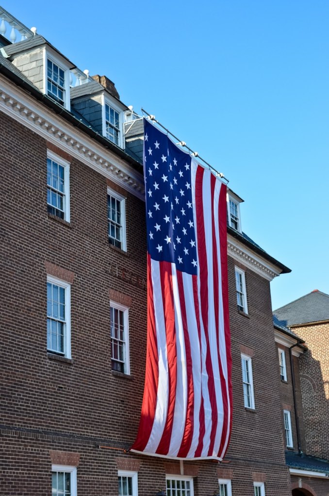 us a flag near brown concrete building during daytime