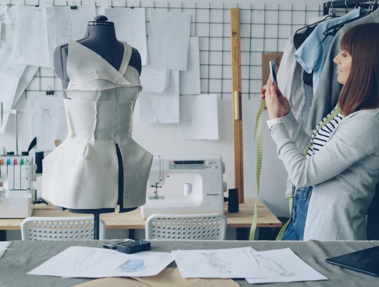 Fashion designer takes a picture of her creation.