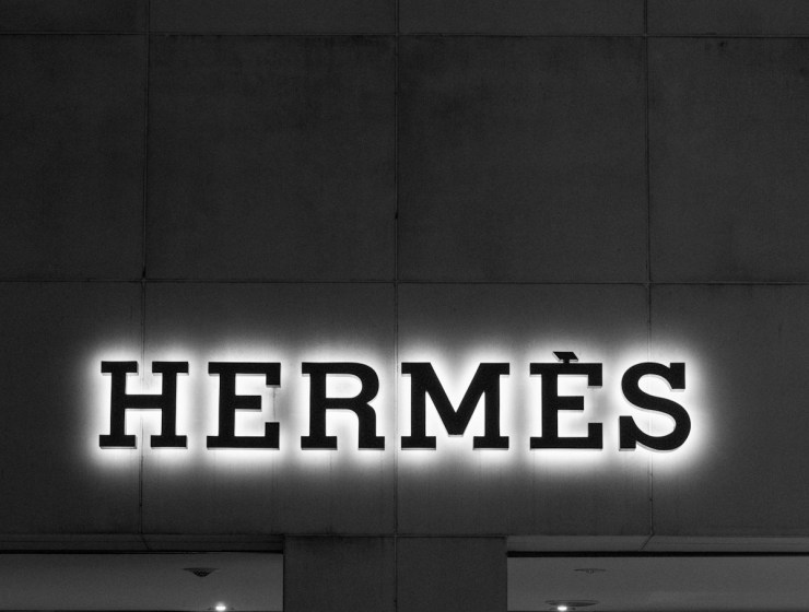 A black and white photo of a building with a neon sign