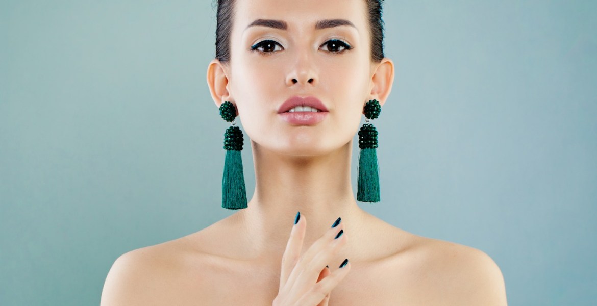 A woman in a strapless dress holding her hands together