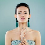 A woman in a strapless dress holding her hands together