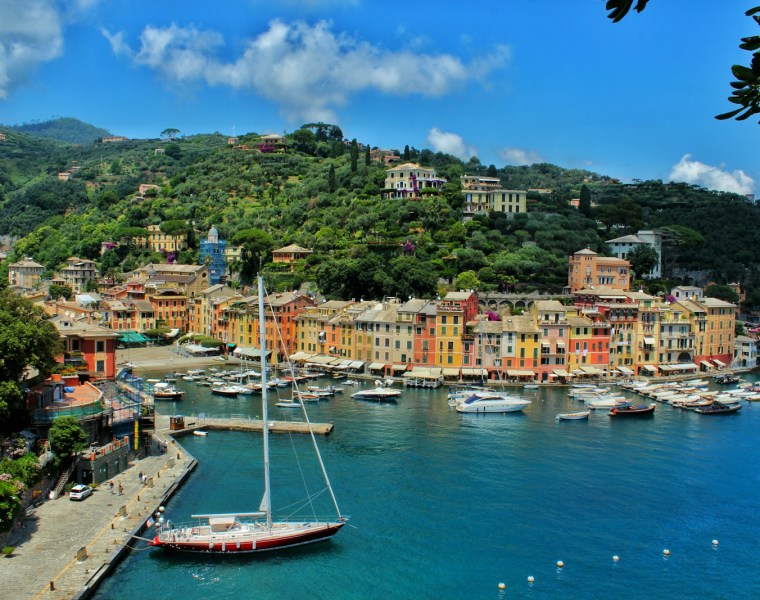 white boat on body of water near Portofino city buildings during daytime
