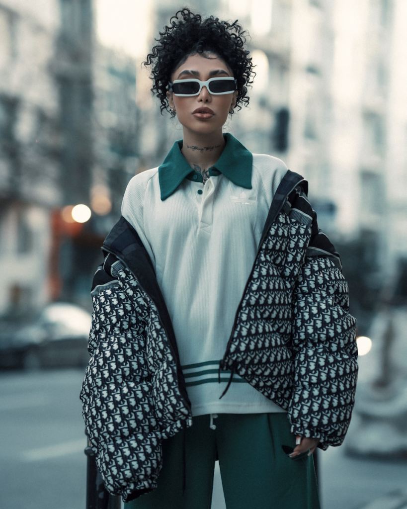 a woman in a white shirt and green pants