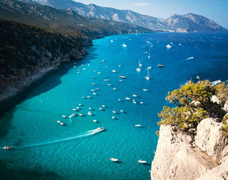 a group of boats floating on top of a body of water