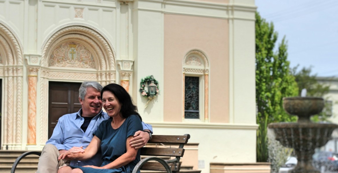 man and woman sitting on bench