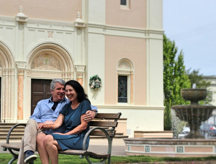 man and woman sitting on bench