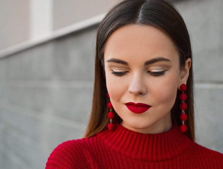 woman looking down wearing red lipstick