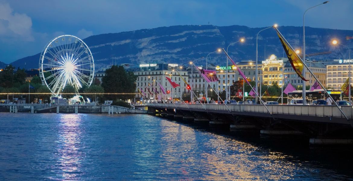 a pier with a ferris wheel and buildings by it