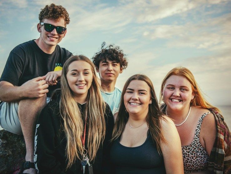 photography of five people near outdoor during daytime