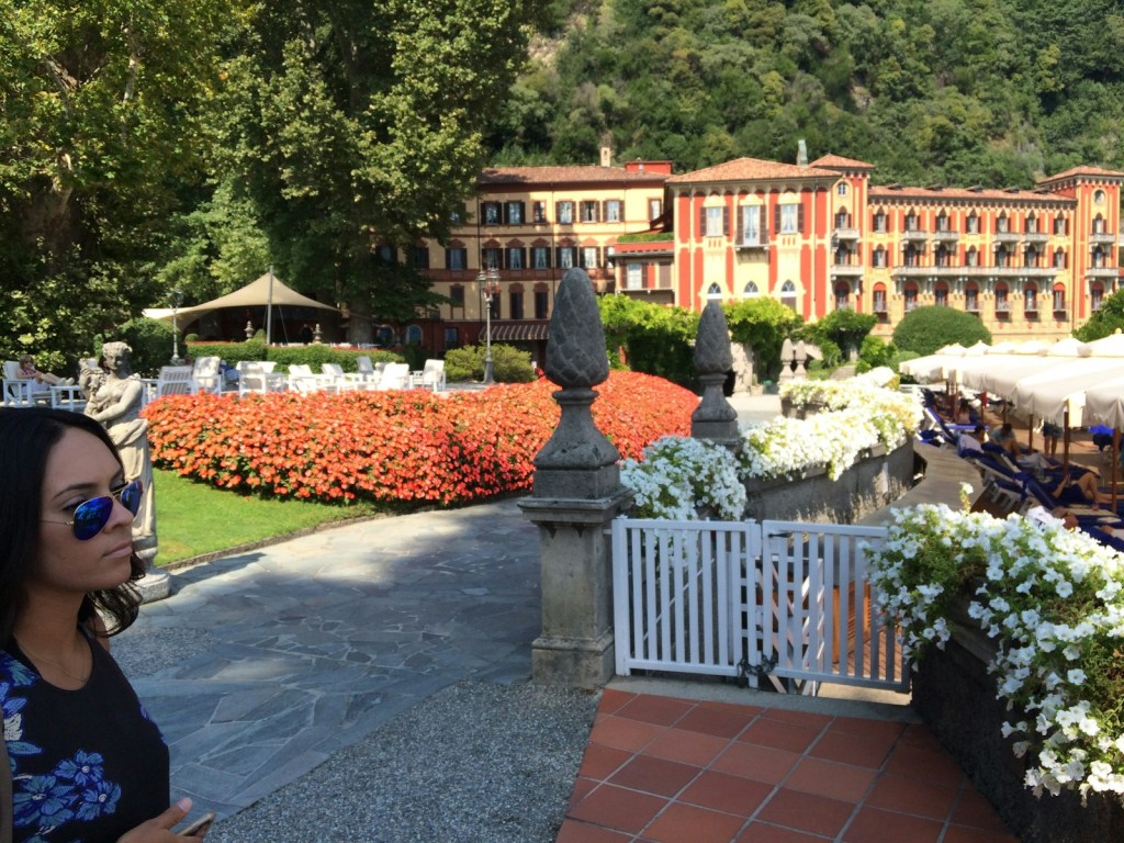 brown and white concrete building near green trees during daytime