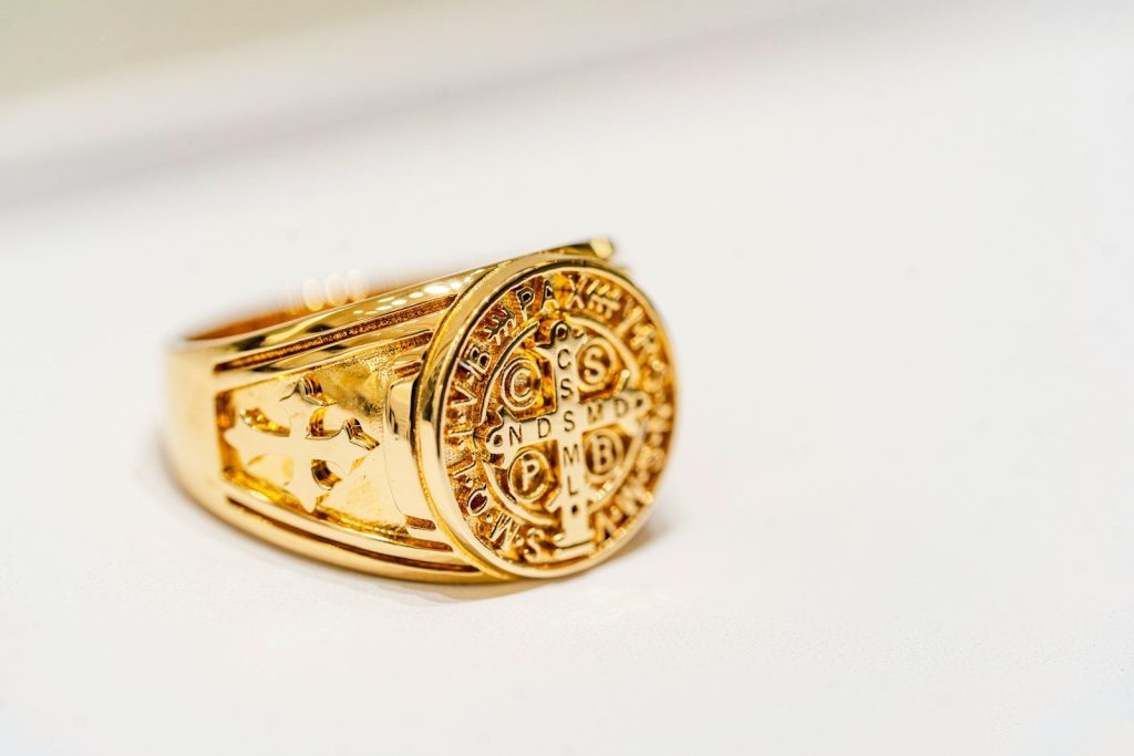 a close up of a gold ring on a white surface
