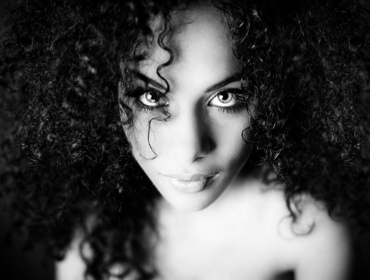 a black and white photo of a woman with curly hair