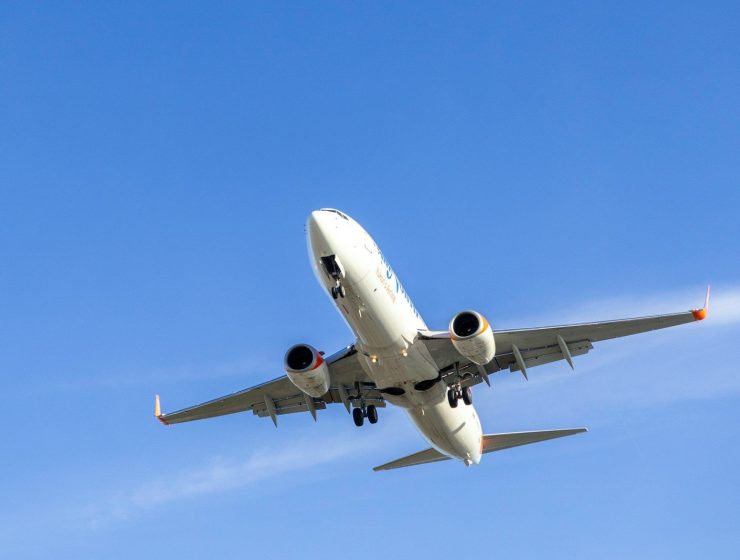 A large jetliner flying through a blue sky