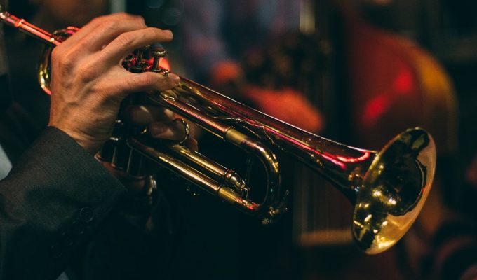 person playing trumpet during night time