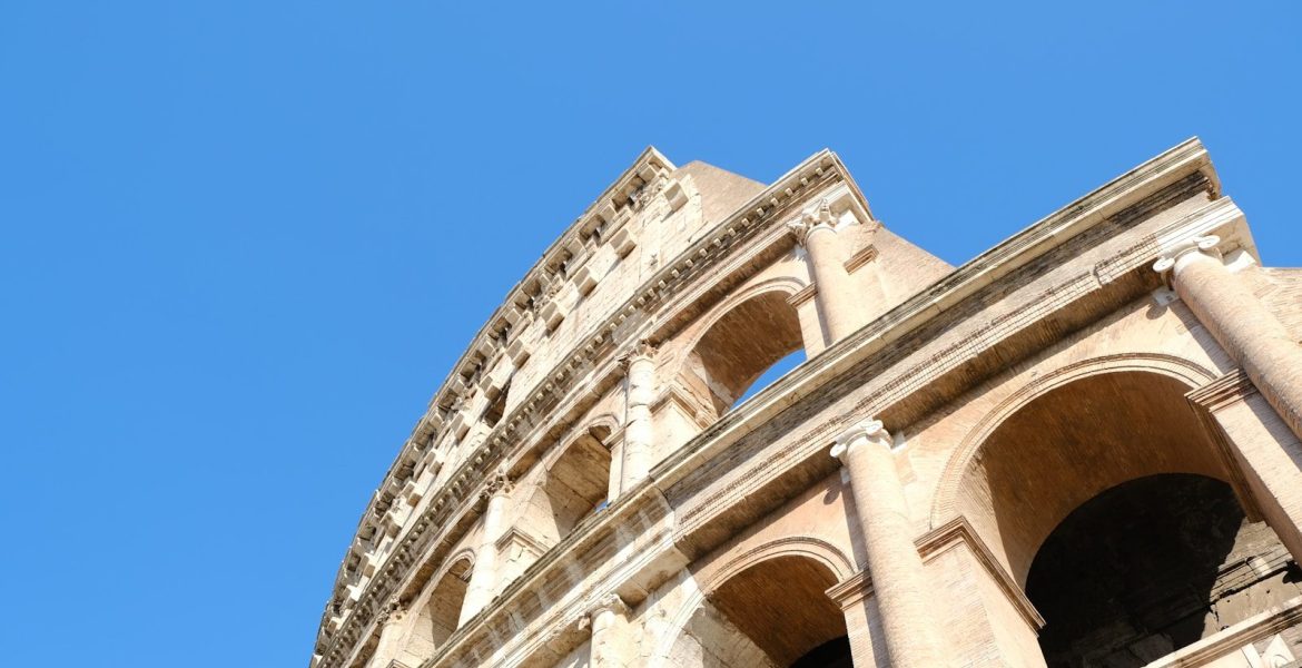 a close up of the top of a building with a blue sky in the background