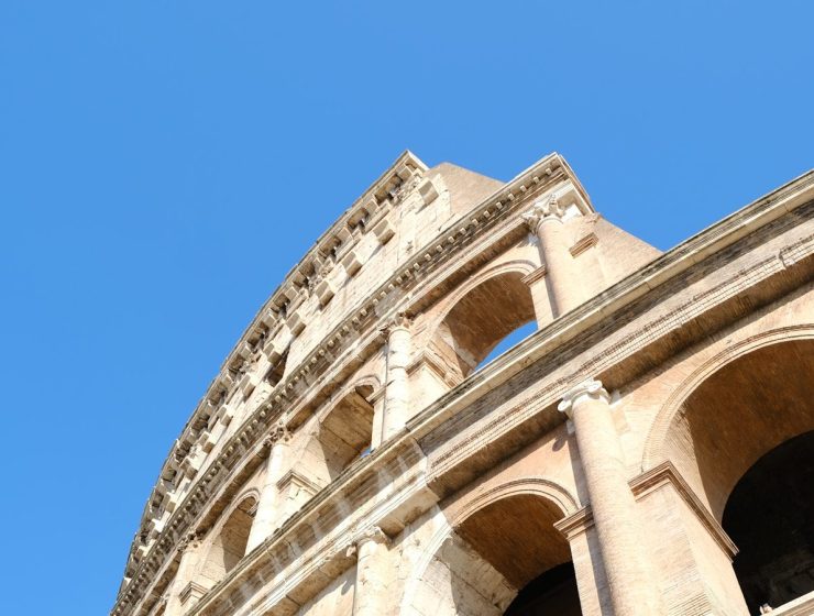 a close up of the top of a building with a blue sky in the background