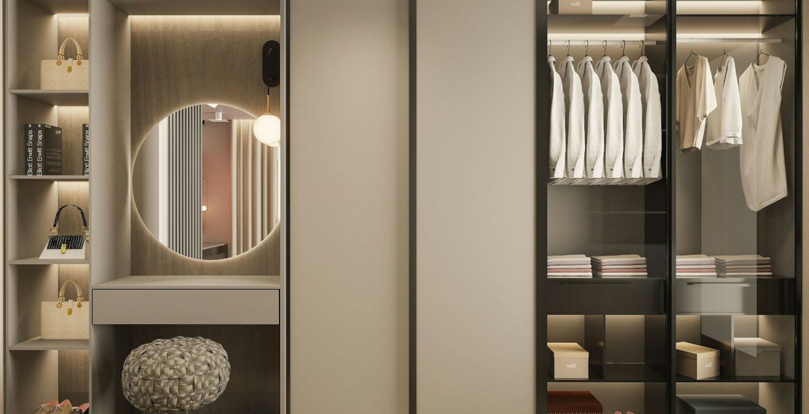 a walk in wardrobe with a mirror and a stool