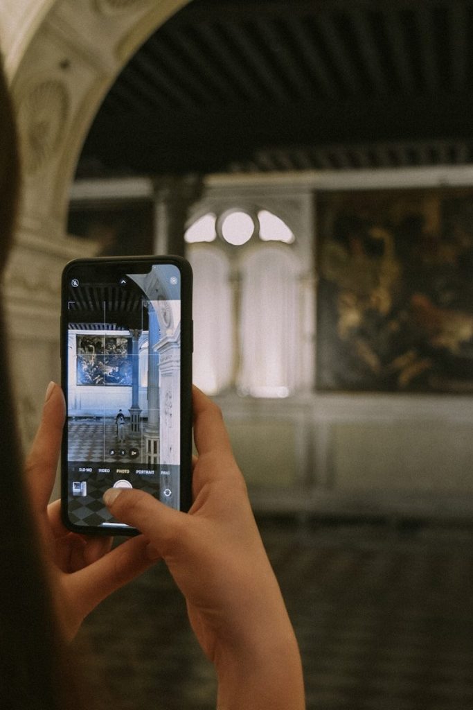 a person taking a picture of a building with a cell phone