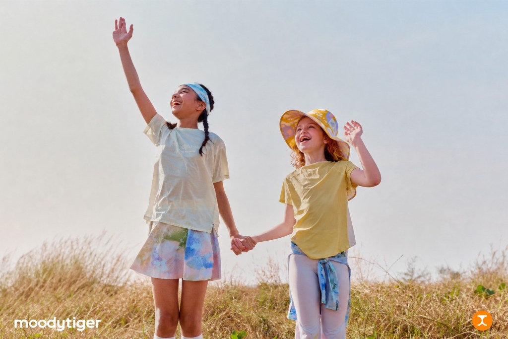 two girls in a park wearing moodytiger brand clothing