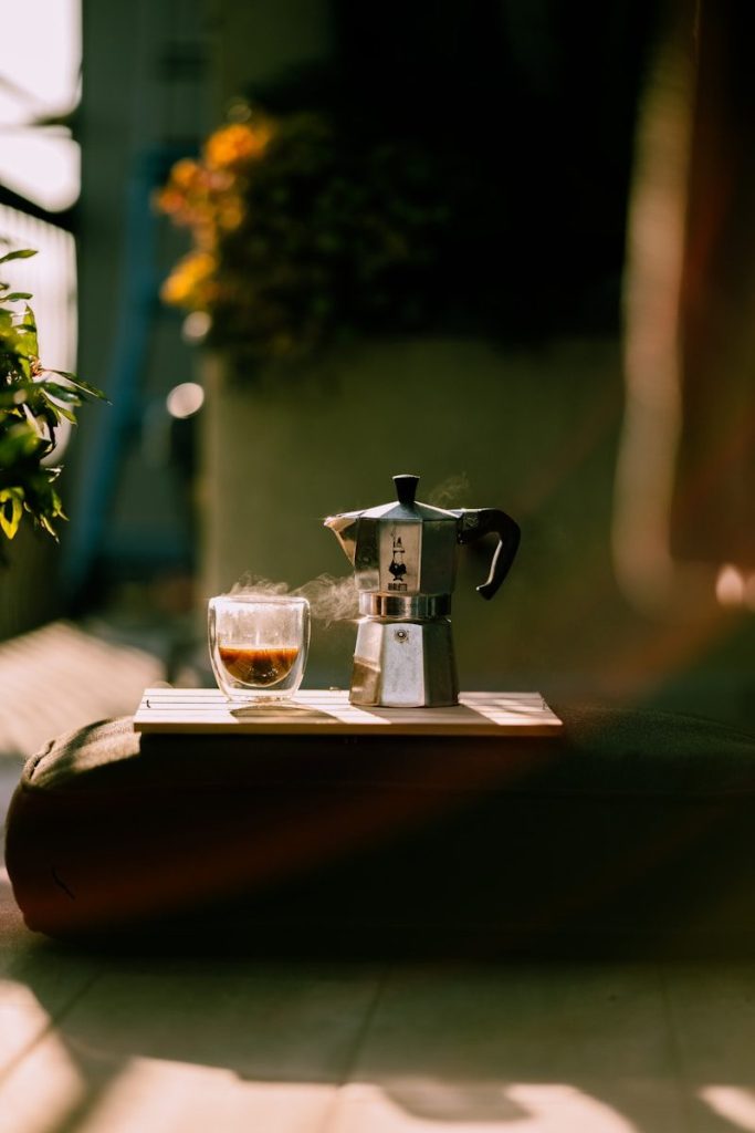 Coffee and a moka pot on a sunny day.