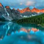 Moraine Lake Canadian Rockies reflecting snow-capped peaks in the Canadian Rockies at golden hour
