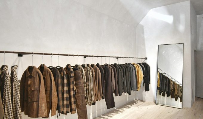 a room with a wall of clothes on the wall