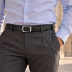 man wearing a belt , with the Milan Duomo in the background